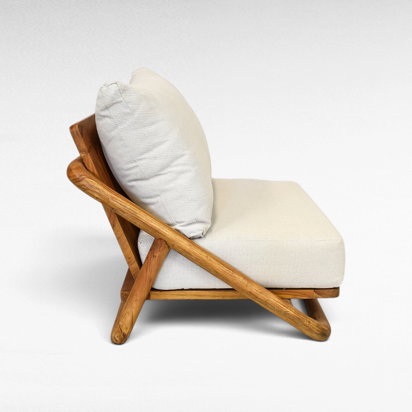 Chora Barefoot Luxury Living teak wood sofa chair with a natural honey finish and off-white upholstered cushions.