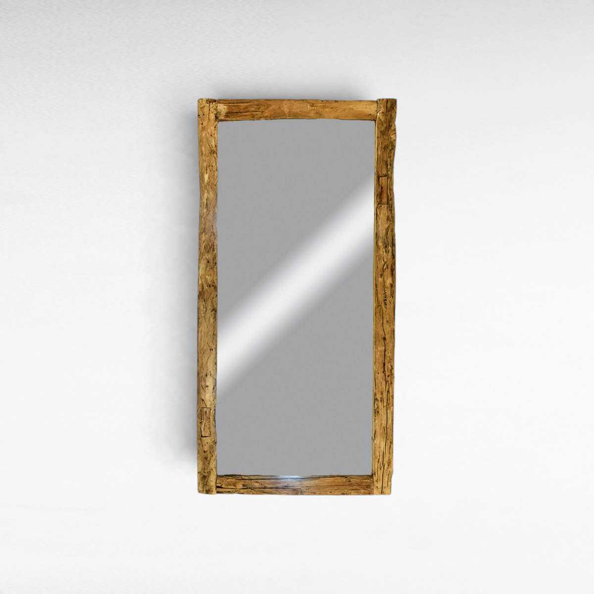 Chora Barefoot Luxury Living rectangular mirror with a rustic, natural teak wood frame on a white wall.