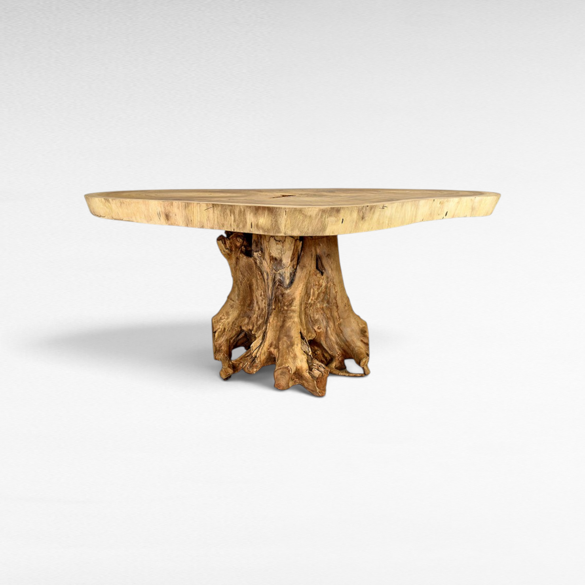 Chora Barefoot Luxury Living Suar wood dining table with a natural live edge slab top and sculptural root base.