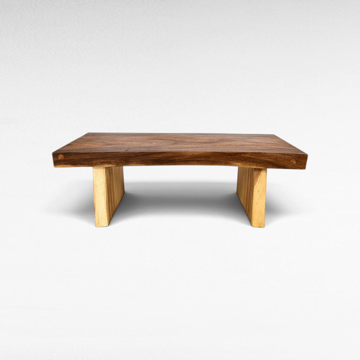 Chora Barefoot Luxury Living suar wood coffee table with a natural live edge top and light wood block legs
