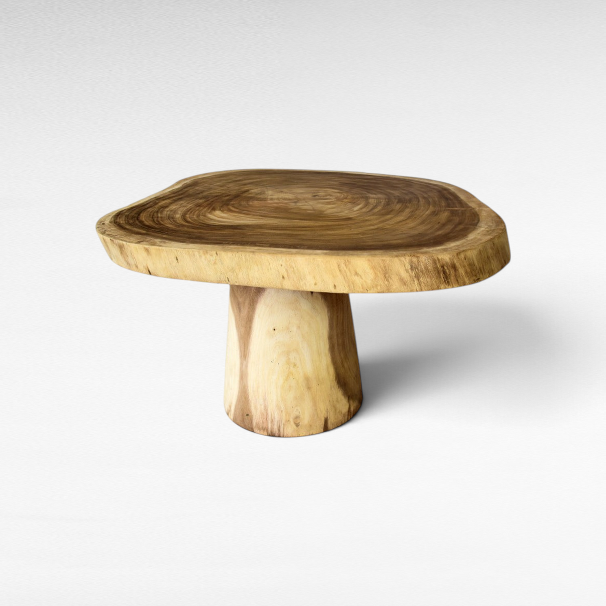 Chora Barefoot Luxury Living natural suar wood dining table with a live edge round top and solid pedestal base