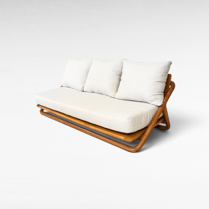 Chora Barefoot Luxury Living teak wood sofa with a honey-toned frame and plush off-white cushions