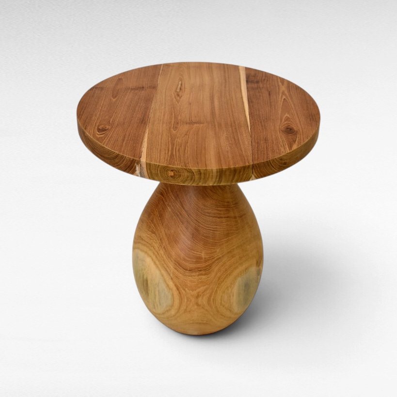 Chora Barefoot Luxury Living round suar wood coffee table with a natural grain finish and pedestal base