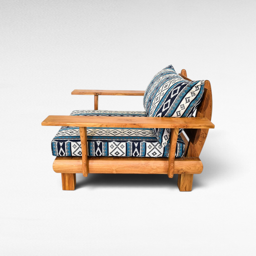 Chora Barefoot Luxury Living teak wood sofa chair with blue and white geometric patterned cushions, side view