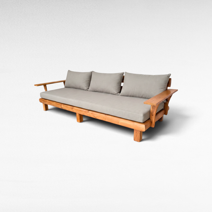 Chora Barefoot Luxury Living teak wood outdoor sofa with grey cushions and wide armrests on a white background