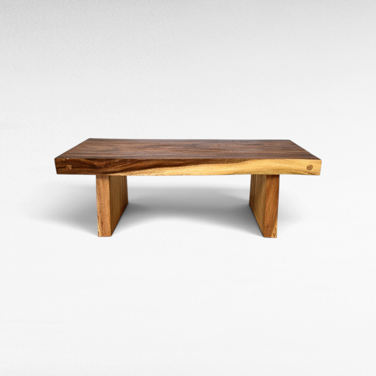 Chora Barefoot Luxury Living suar wood coffee table with a natural live edge finish and sturdy block legs.