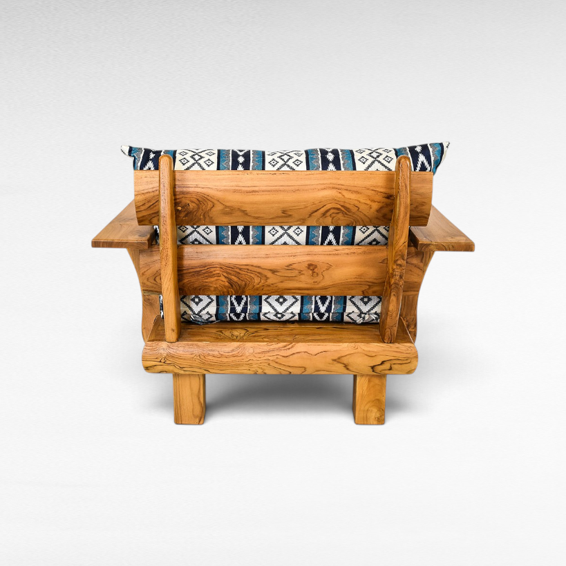 Chora Barefoot Luxury Living teak wood sofa chair with blue and white patterned cushions, back view