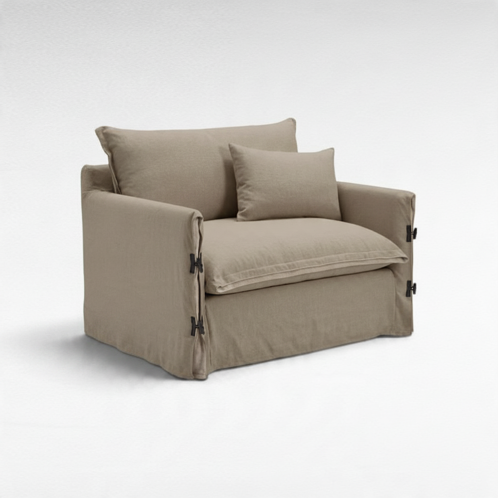 Chora Barefoot Luxury Living two-seater sofa in beige linen with side buckle details and matching throw pillow