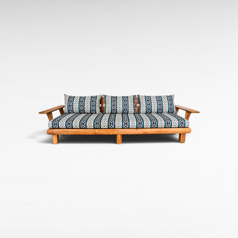 Chora Barefoot Luxury Living teak wood sofa with blue and white patterned cushions on a white background
