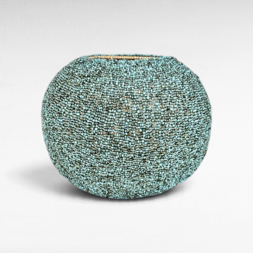 Chora Barefoot Luxury Living light blue and green beaded rattan basket with a textured, artisanal finish.