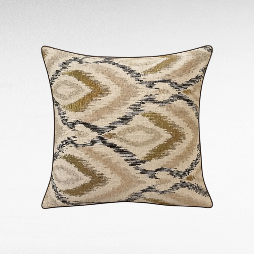 Chora Barefoot Luxury Living square decorative throw pillow with a beige and olive green ikat-inspired geometric pattern
