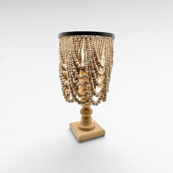 Chora Barefoot Luxury Living bleached wood beaded table lamp with black metal accents and a square base.