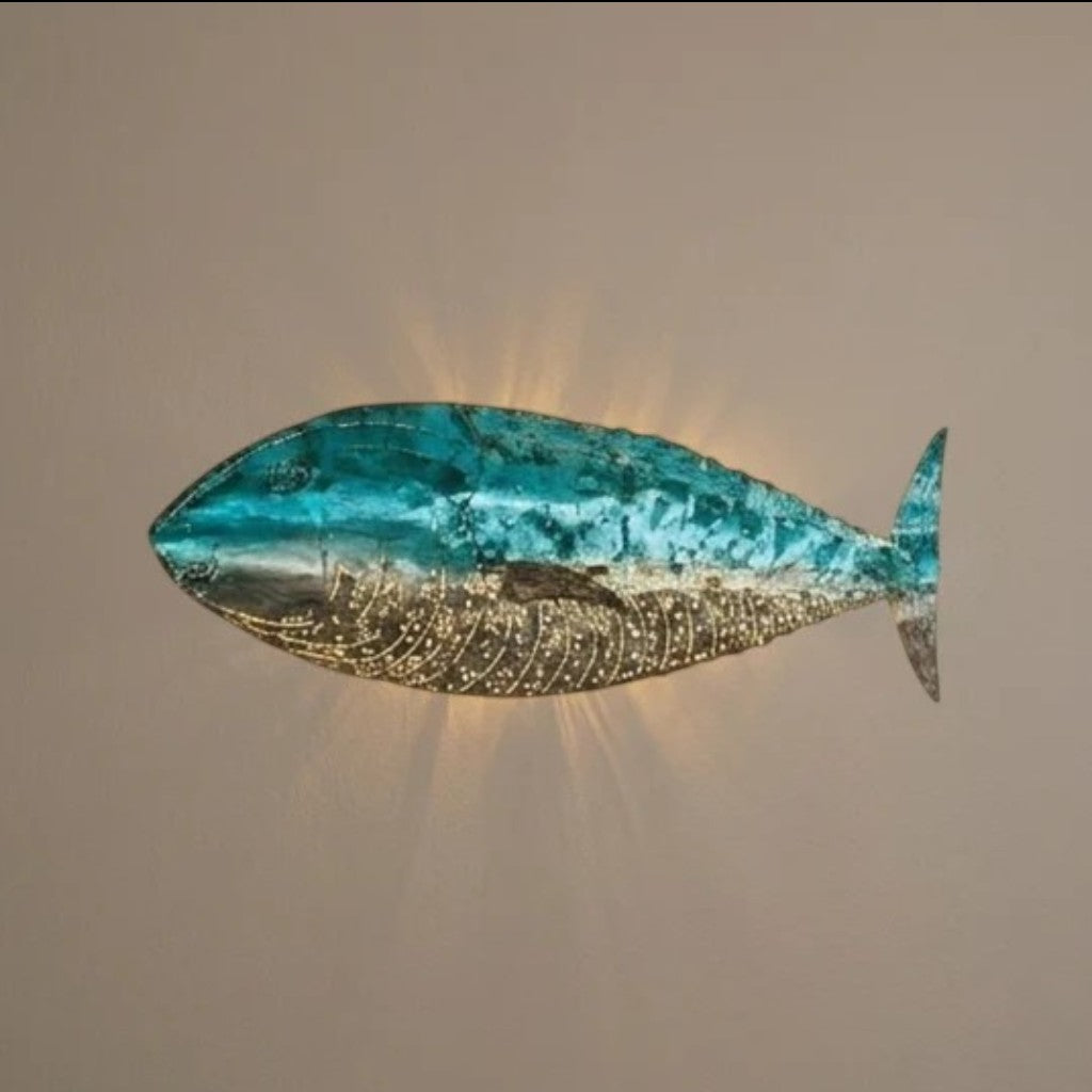 Chora Barefoot Luxury Living blue and silver fish wall lamp with intricate detailing and a serene glow.
