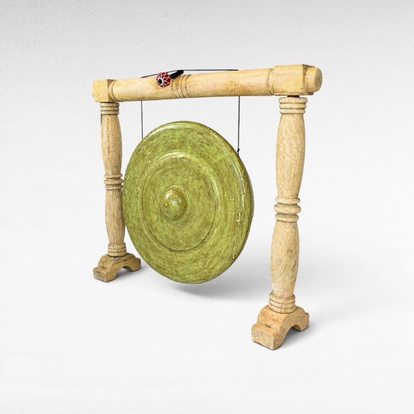 Chora Barefoot Luxury Living ceremonial gong decoration, green distressed finish, on a wooden stand.