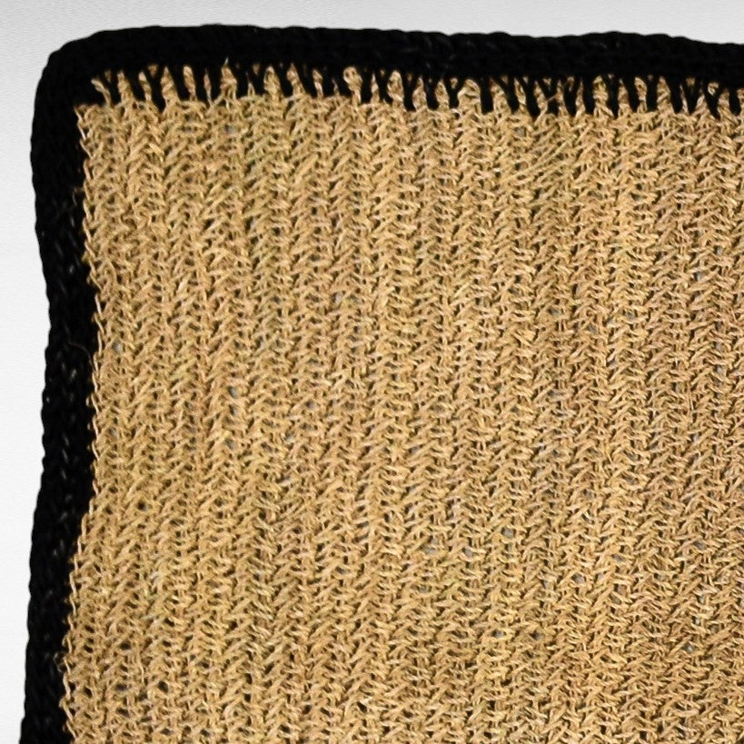 Chora Barefoot Luxury Living natural fiber rug with black border, woven texture, 90cm diameter