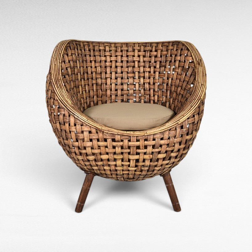 Chora Barefoot Luxury Living round rattan armchair with beige cushion and tapered wooden legs