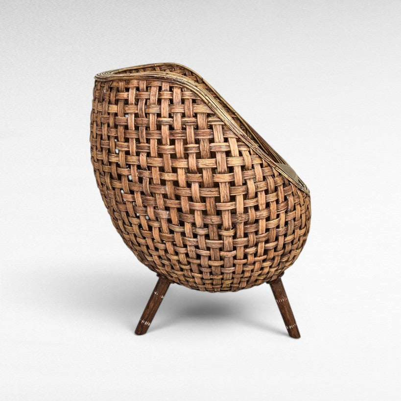 Chora Barefoot Luxury Living woven rattan armchair with wooden legs. Natural brown, egg-shaped design.