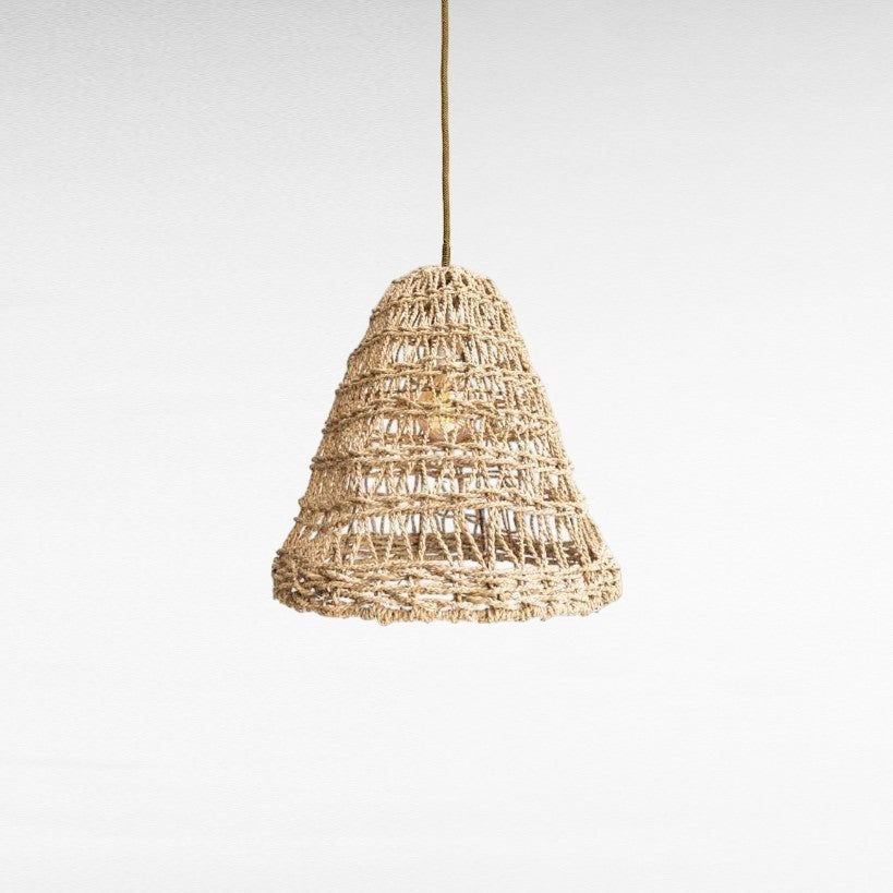 Chora Barefoot Luxury Living natural rattan cone pendant light with woven texture and visible bulb socket.