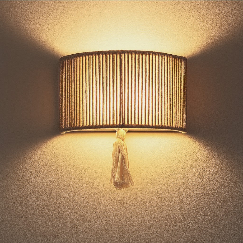 Chora Barefoot Luxury Living natural cotton rope and metal frame wall lamp with tassel detail, 33cm wide.