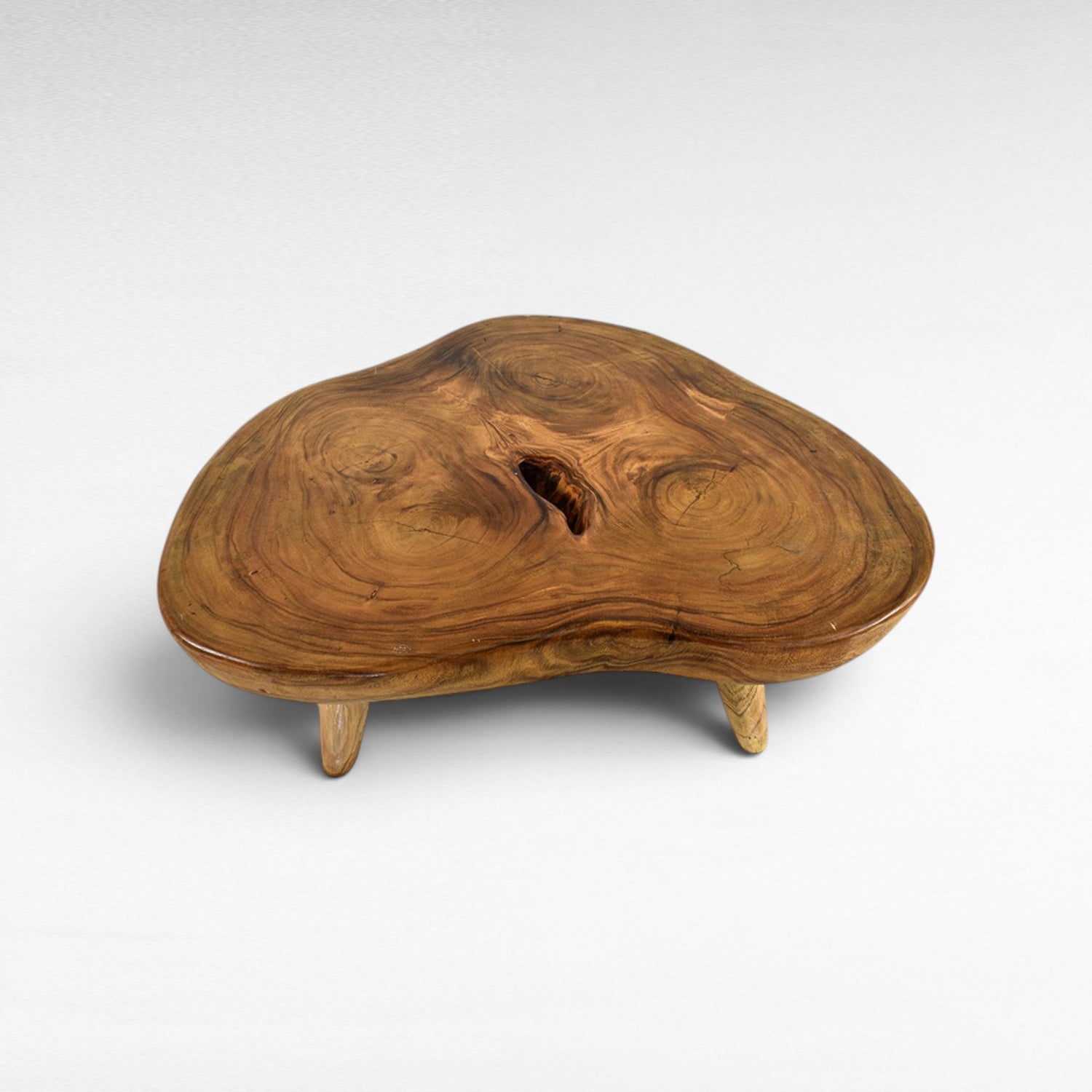 Chora Barefoot Luxury Living natural suar wood coffee table with organic grain and unique knot detail. Honey tones.