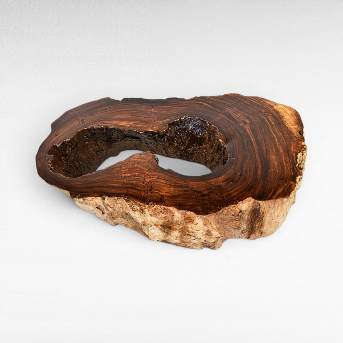 Chora Barefoot Luxury Living natural suar wood coffee table with hollow center and rough bark edge. Rich brown tones.