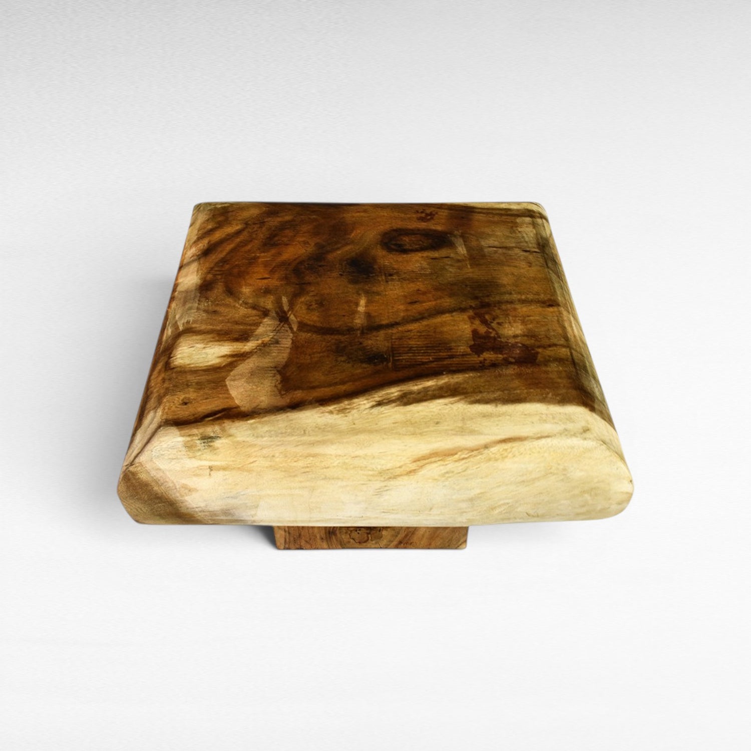 Chora Barefoot Luxury Living natural suar wood square coffee table with unique grain patterns and a light wood base.