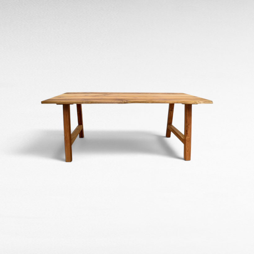 Chora Barefoot Luxury Living handcrafted suar wood dining table with natural live edge and organic grain patterns.