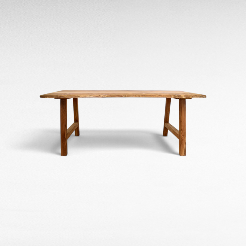 Chora Barefoot Luxury Living handcrafted suar wood dining table with a natural live edge and sturdy trestle base