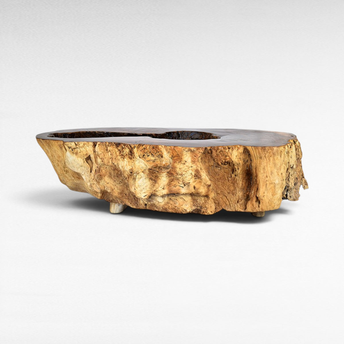 Chora Barefoot Luxury Living natural suar wood hollow coffee table with rough bark texture and smooth top.
