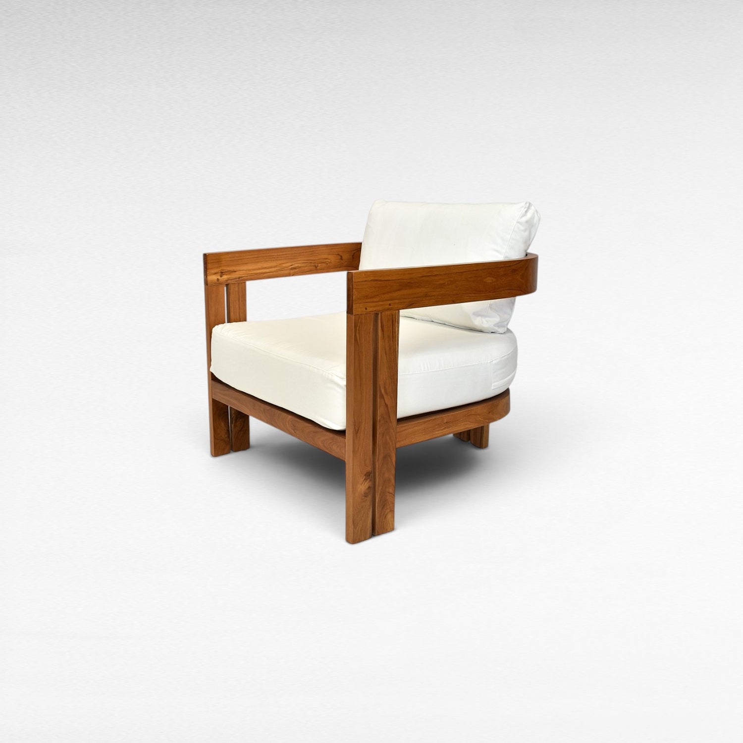 Chora Barefoot Luxury Living teak wood armchair with white cushions and curved armrests.
