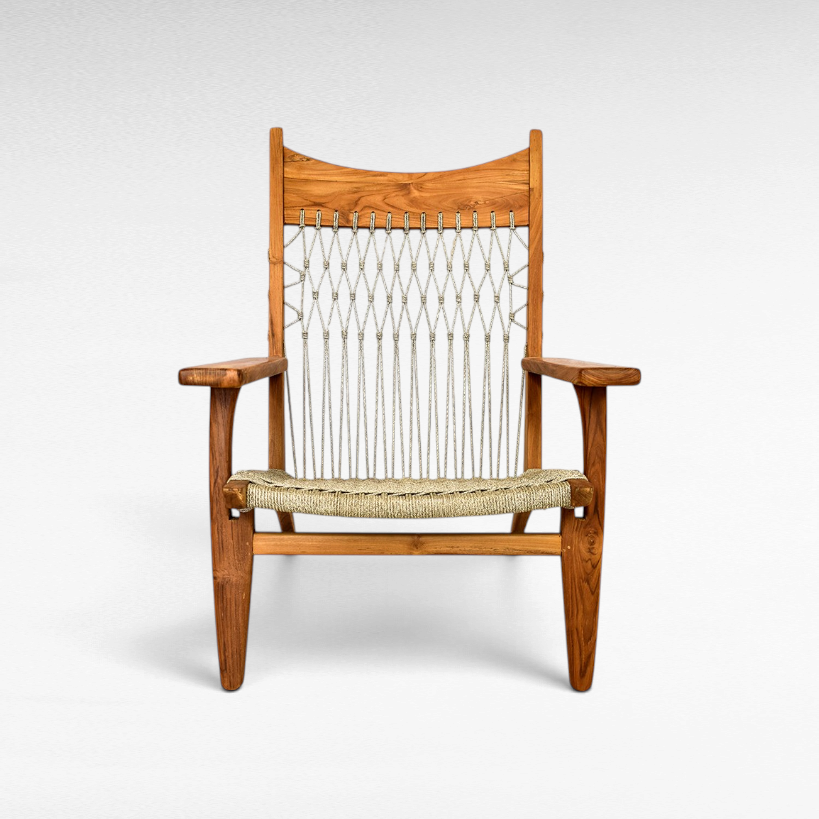 Chora Barefoot Luxury Living teak wood armchair with a woven synthetic raffia seat and decorative knotted backrest.