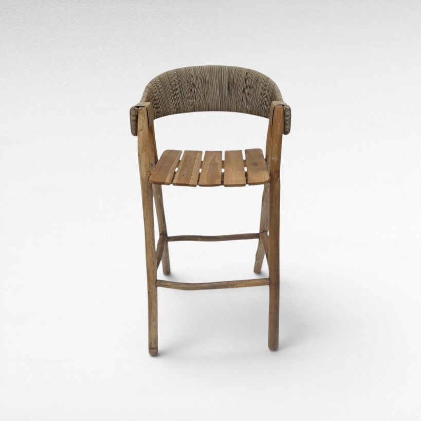 Chora Barefoot Luxury Living teak wood bar stool with woven synthetic raffia seat and back. Natural wood finish.
