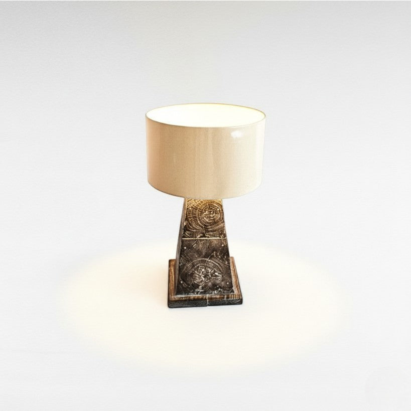 Chora Barefoot Luxury Living teak wood table lamp with a cream drum shade and a textured, dark wood base featuring wood grain details.