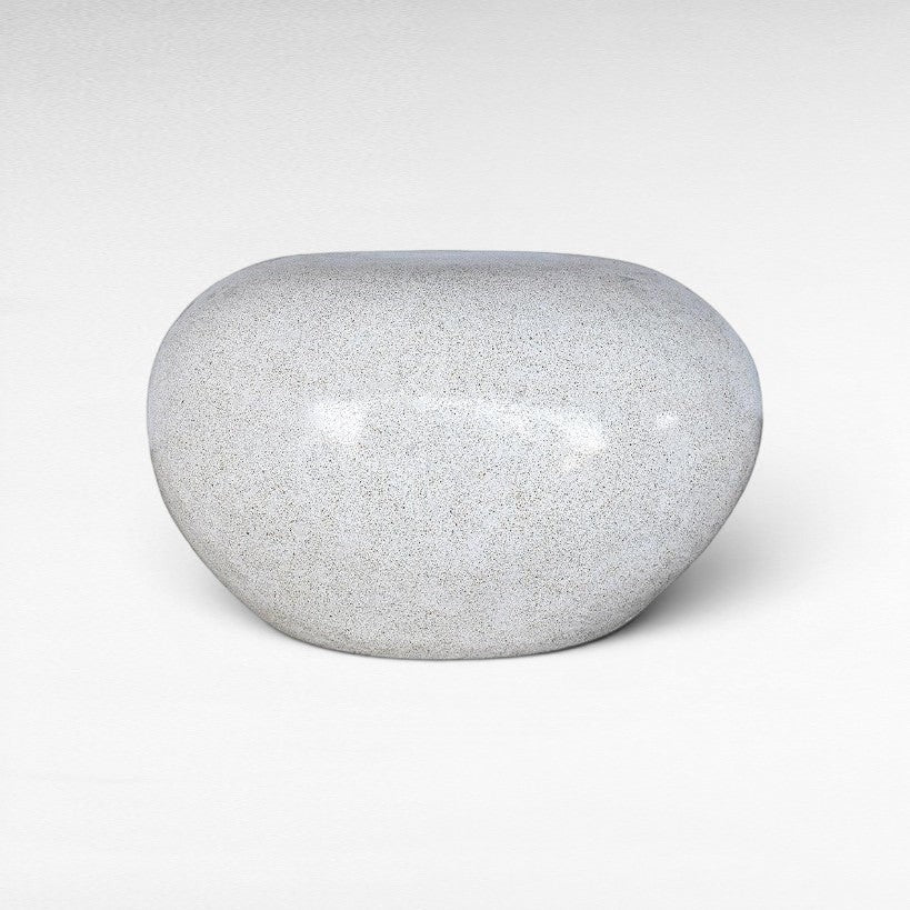 Chora Barefoot Luxury Living terrazzo stool in dirty white with a smooth, rounded pebble-like shape.