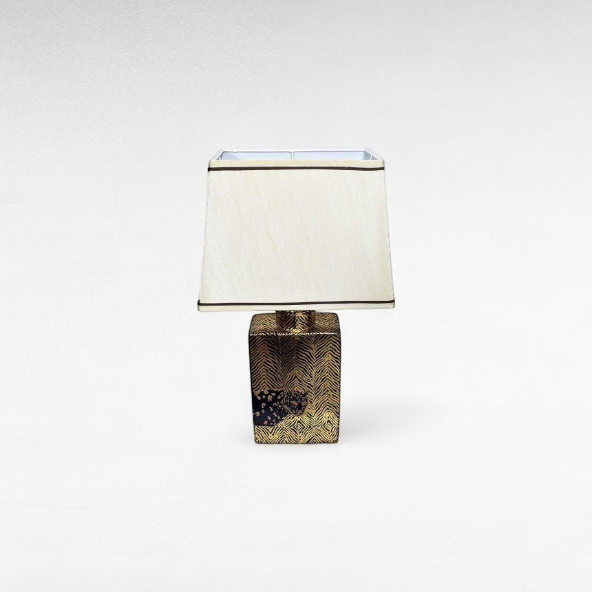 Chora Barefoot Luxury Living gold and black tiger print table lamp with cream shade.