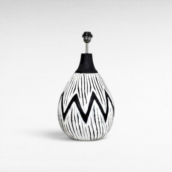 Chora Barefoot Luxury Living white and black wood table lamp with a zigzag pattern and a black neck.