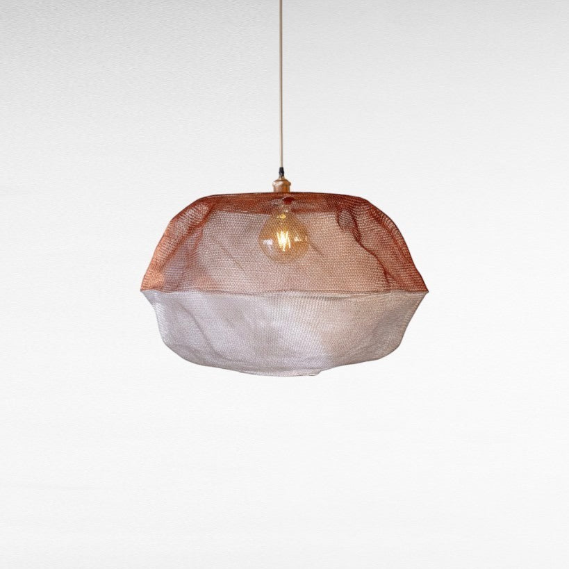 Chora Barefoot Luxury Living handwoven metal wire pendant light in cloud shape, copper and silver mesh, with exposed bulb.