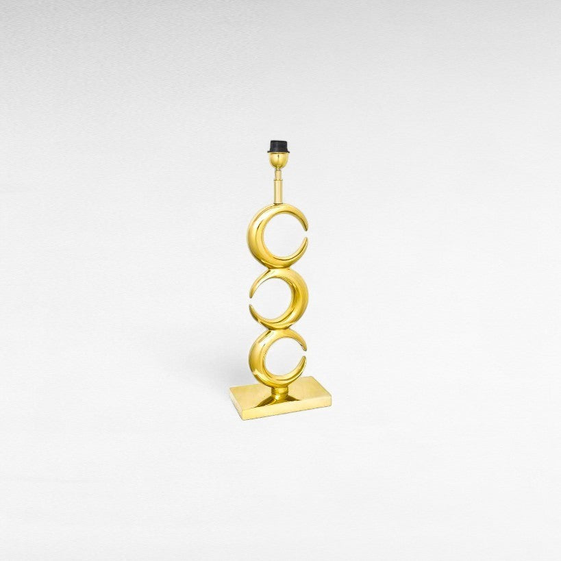 Chora Barefoot Luxury Living gold metal table lamp with three stacked crescent moon shapes on a rectangular base.