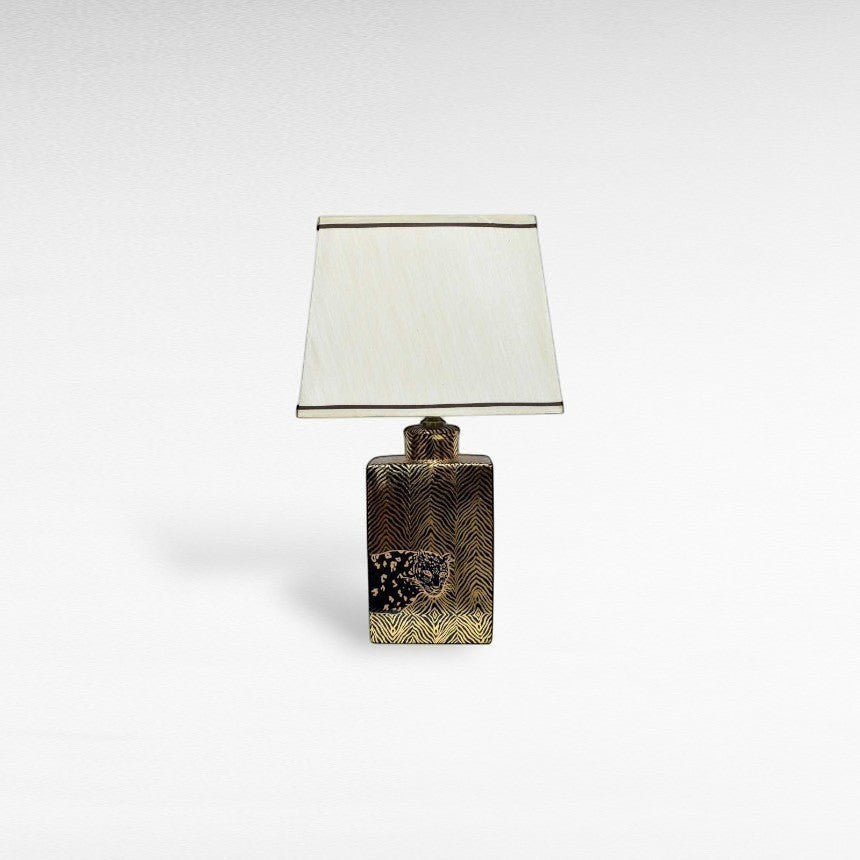 Chora Barefoot Luxury Living gold and black tiger table lamp with a cream lampshade.