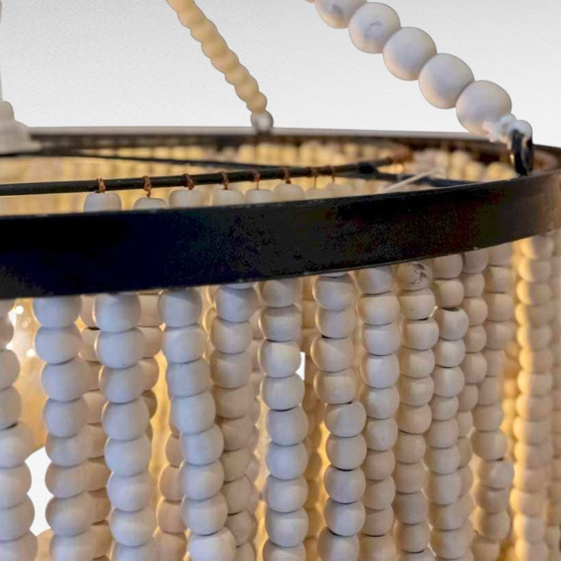 Chora Barefoot Luxury Living Ivory Cascade beaded chandelier with loops of wooden beads on a metal frame.