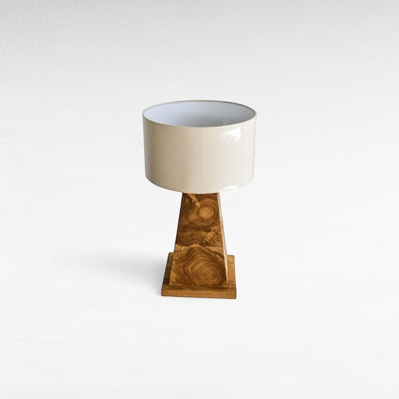 Chora Barefoot Luxury Living natural teak wood table lamp with beige drum shade and unique wood grain base.