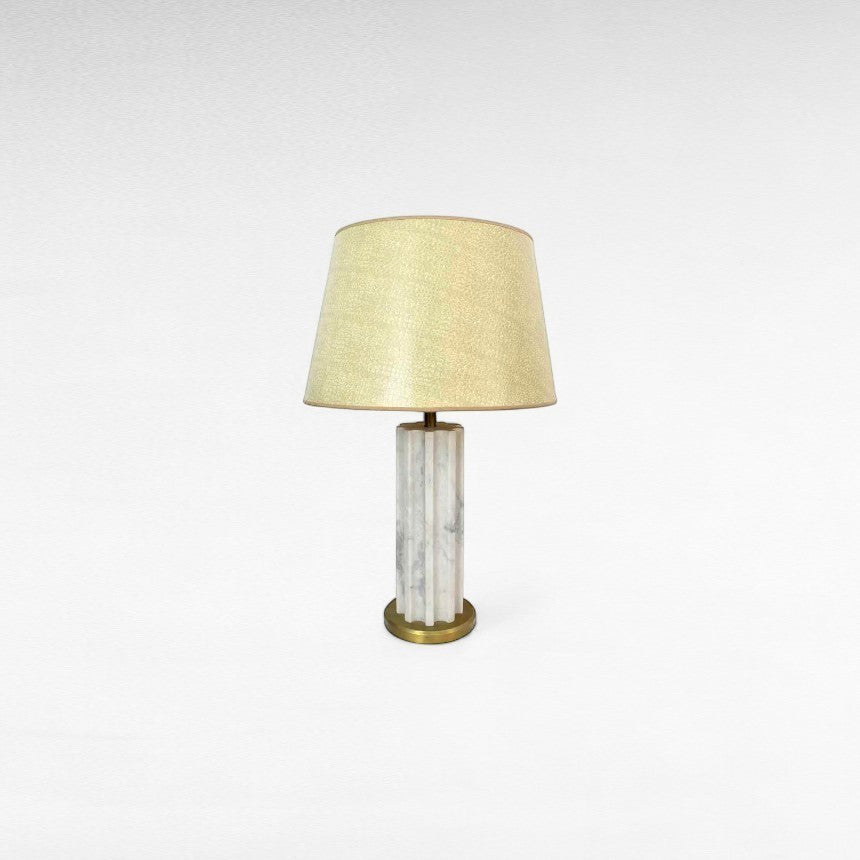 Chora Barefoot Luxury Living white and gold marble metal table lamp with a fluted column base and a textured cream lampshade.