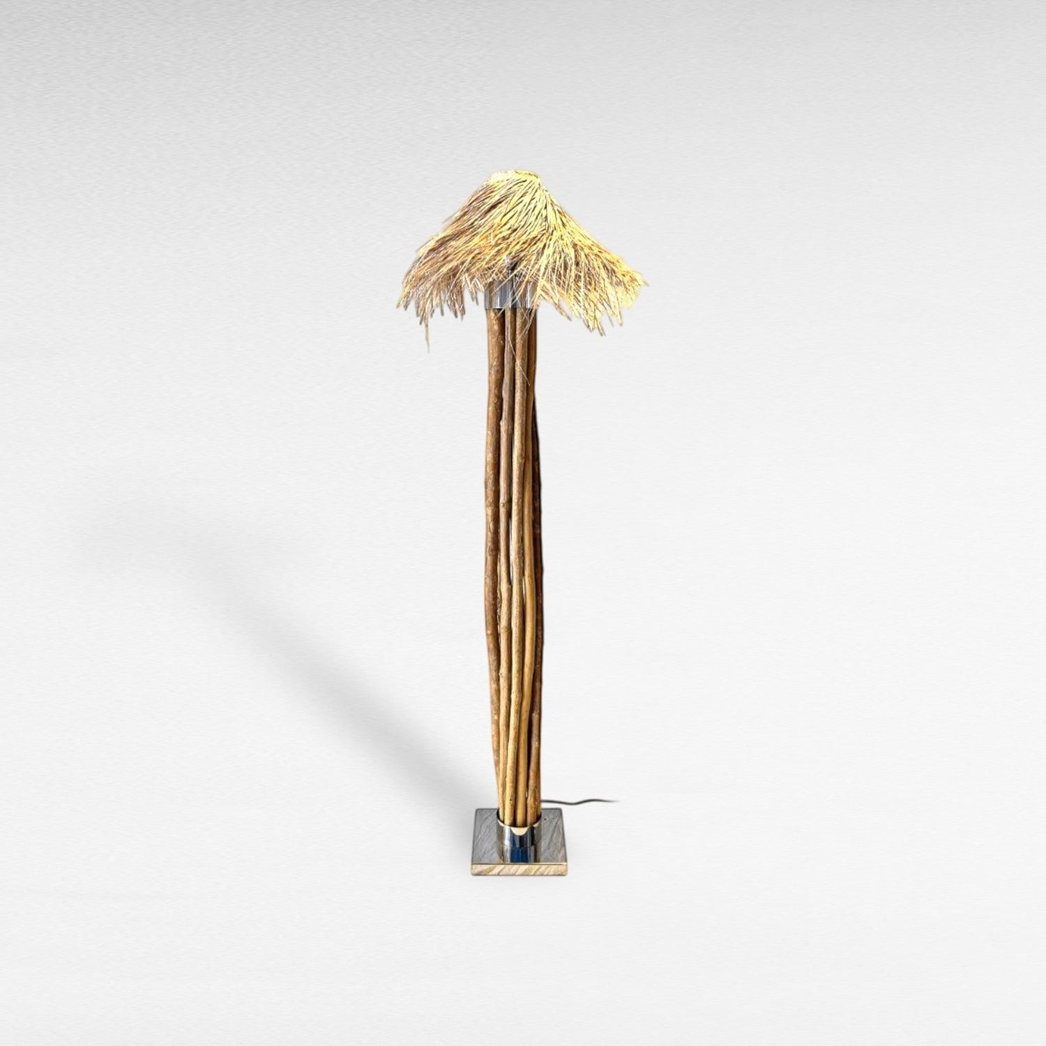 Chora Barefoot Luxury Living floor lamp with natural wood branches, stainless steel base, and woven raffia shade. Tall, natural-inspired design.