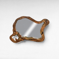 Chora Barefoot Luxury Living teak wood mirror with an organic, irregular live-edge frame on a white wall.