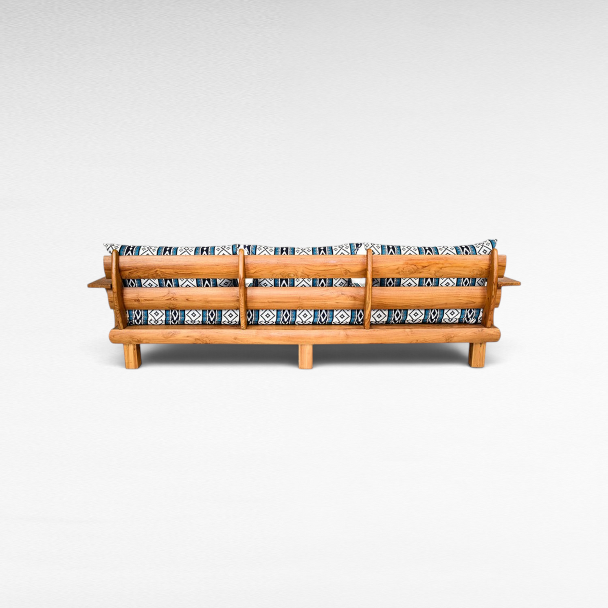 Chora Barefoot Luxury Living teak wood sofa with patterned blue and white cushions, back view