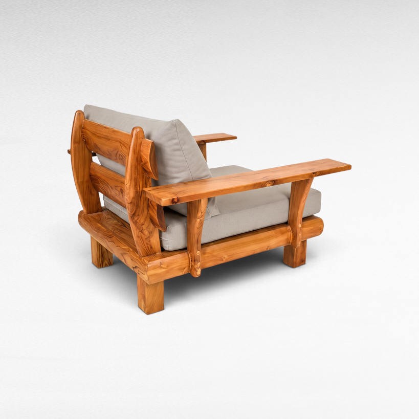 Chora Barefoot Luxury Living teak wood armchair with solid wooden armrests and comfortable grey fabric cushions.