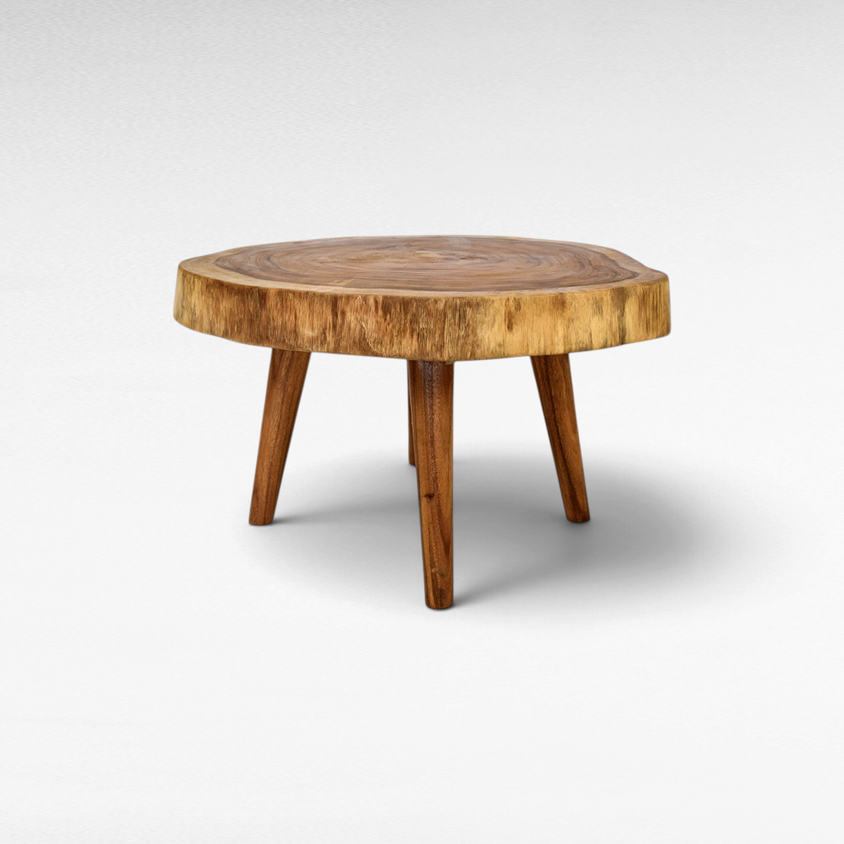 Chora Barefoot Luxury Living round coffee table made from a natural live-edge wood slab with three sturdy legs.