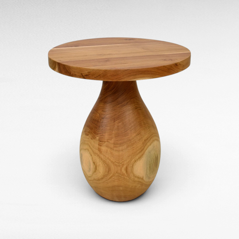 Chora Barefoot Luxury Living round suar wood coffee table with a unique teardrop pedestal base