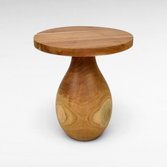 Chora Barefoot Luxury Living round suar wood coffee table with a unique teardrop pedestal base