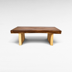 Chora Barefoot Luxury Living suar wood coffee table with a natural live edge top and light wood block legs